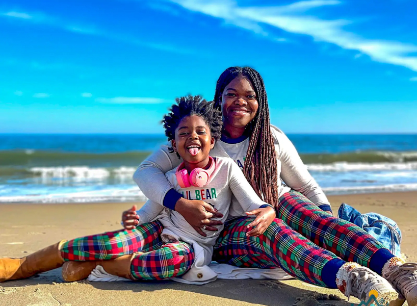 single mom and daughter on beach