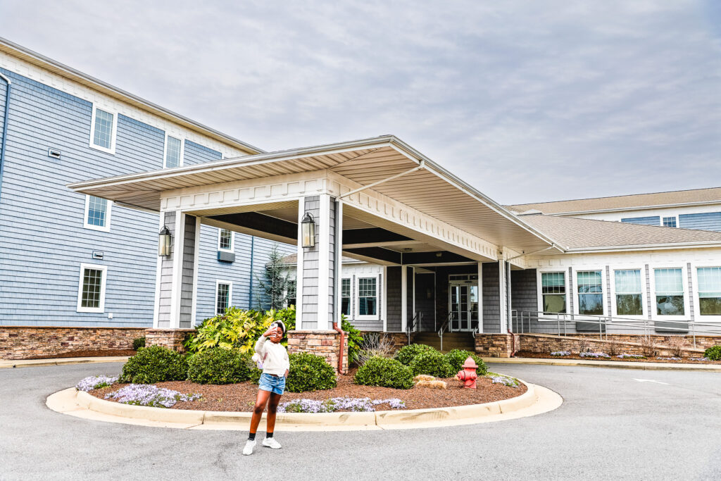 child standing in front of hotel comfort suites