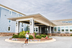 child standing in front of hotel comfort suites