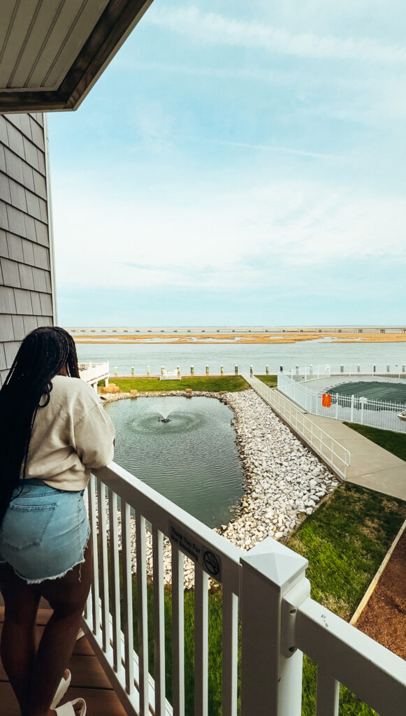 woman standing on balcony of hotel