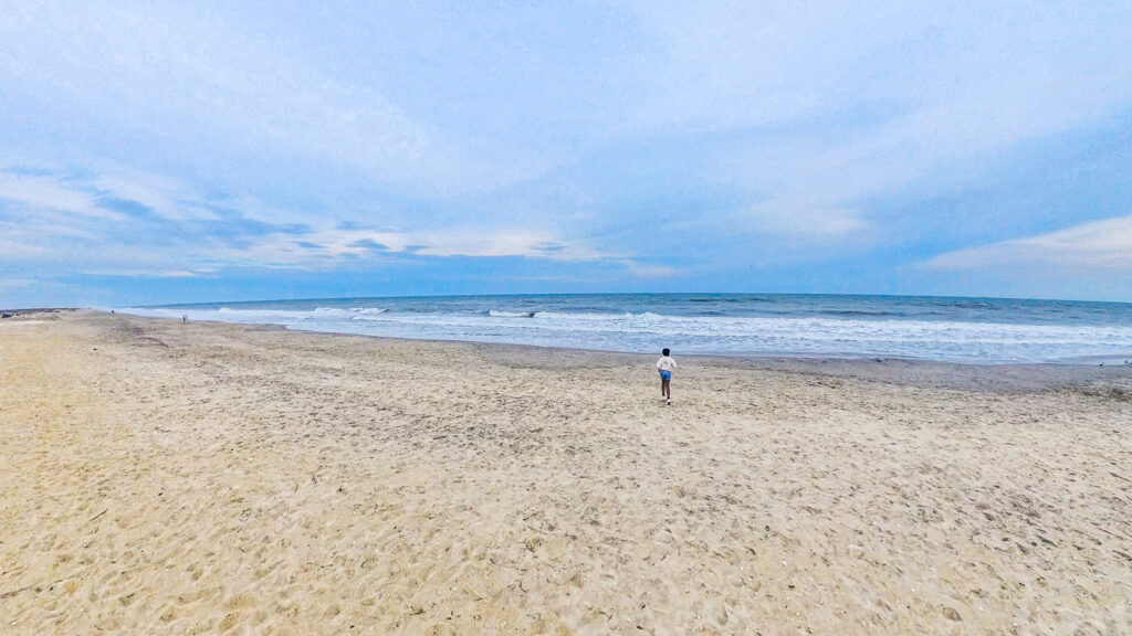 child standing on beach